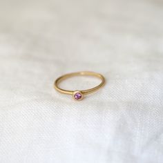 A lightweight 14k gold band with a gorgeous 2.5mm rose cut pink garnet - thinner than our Sola collection but with a larger stone! Perfect for stacking, birthstone gifts, or an affordable token of love. Pink 14k Gold Birthstone Ring With Round Cut, Pink 14k Gold Round Cut Birthstone Ring, 14k Gold Pink Birthstone Ring With Round Cut, Dainty Rose Gold Sapphire Birthstone Ring, Pink Stackable Rings As Gift, Pink Ruby Birthstone Ring In 14k Gold, 14k Gold Pink Ruby Ring Birthstone, Pink Stackable Rings With Round Cut As A Gift, Pink Stackable Rings With Round Cut For Gifts