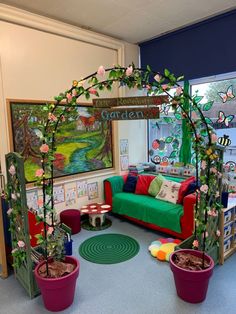 a living room filled with potted plants next to a green couch and colorful walls