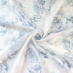 the fabric is white and blue with grey swirls