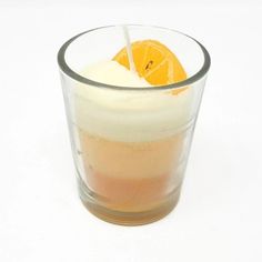 an orange slice is in a glass with ice and water on the rim, along with a straw sticking out of it