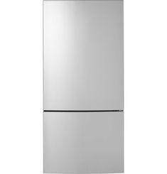 a silver refrigerator freezer sitting on top of a white wall