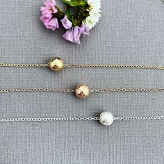 "✦Looking for a minimalist necklace to give your bridesmaids? This might just be the perfect necklace!   ✦A beautiful, sparkly stardust bead, measuring 8mm in diameter, is threaded through and floats on a delicate flat cable chain with link size of 1.6mm. Made of your choice of all 14k gold filled, 14k rose gold filled, or sterling silver.  ✦The chain closes with a spring clasp and loop and comes in your choice of length from 14 to 20\".  Please select necklace length and metal type at check-out. ✦Your jewelry will be packaged in a beautiful and reusable organza bag. All items will be placed in the same organza bag. If you need a separate bag for each item, please leave a comment at check out. ✦Giving your purchase as a gift? If you would prefer that prices not be printed on your invoice, Diy Jewelry Projects, Single Bead, Bridesmaid Proposal Gifts, Proposal Gifts, Jewelry Card, Wedding Jewellery Necklace, Layering Necklace, Minimalist Necklace, Bridesmaid Proposal