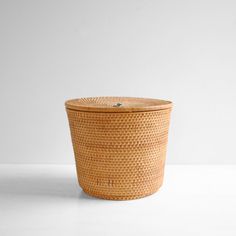 a large woven basket sitting on top of a white table