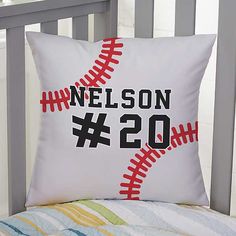 a baseball pillow sitting on top of a bed