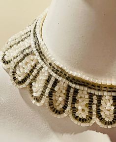 "A gorgeous antique bespoke collar choker made in Germany -- it's from the Victorian / Edwardian era or before.  This is truly a treasure -- I've never seen a collar choker as fine as this one is outside of a museum collection.  The prettiest rectangular pearlescent white and silver bugle beads are hand sewn in petal sections on a gently scalloped collar made of white-beige antique muslin linen.  This bespoke piece has a glowing ember shine -- not the bright glittering sparkle of rhinestones -- more of the warm imperial glow that pearls have.  It's just lovely -- old Europe's high end jewelry has extraordinary beauty & charm.  This was obviously a piece made by German jewelers for a high born lady -- perhaps even a  aristocratic or royal one.  It definitely exudes an Imperial Europe aesthe Vintage Gold Necklace With Bead Caps, Vintage Handmade Beaded Necklaces For Wedding, Antique White Beaded Necklace, Vintage Gold Beaded Necklaces For Wedding, Vintage Gold Beaded Wedding Necklaces, Traditional Embellished Necklaces For Parties, Traditional Embellished Party Necklace, Vintage Wedding Gold Beaded Necklaces, Traditional Embellished Necklace For Party