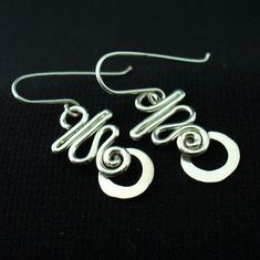 These earrings are hand crafted in solid sterling silver.I use 16 gauge wire for these so they're nice and light but not flimsy.For a unique,long lasting and clearly handmade pair of everyday dangles that won't break the bank.These will do the trick. Unique Sterling Silver Pierced Wrap Earrings, Nickel-free Sterling Silver Earrings, Unique Sterling Silver Wrap Earrings, Handmade Spiral Sterling Silver Wrap Earrings, Modern Handmade Sterling Silver Hoop Earrings, Adjustable Minimalist Sterling Silver Wrap Earrings, Adjustable Hypoallergenic Sterling Silver Wrap Earrings, Handmade Unique Sterling Silver Hoop Earrings, Handmade Adjustable Sterling Silver Earrings