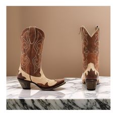 Idyllwind Women's Speedway (Snip Toe) Western Boots Medium Sizes, featuring a classic brown color scheme and a chic tan vamp with a brown shaft and intricate overlay design that adds a touch of sophistication to your outfit. Made from high-quality leather, these boots offer a timeless and stylish look that's perfect for any occasion. The snip toe and pull-on style with pull tabs make these boots easy to slip on and off, while the 12" shaft height provides coverage and support. The Western heel a Brown Closed Toe Boots For Ranch, Country Style Brown Boots With Reinforced Heel, Closed Toe Brown Boots For Ranch, Fitted Beige Boots For Ranch, Retro Brown Boots For Ranch, Retro Brown Boots With Leather Sole, Vintage Beige Closed Toe Boots, Brown Almond Toe Boots For Rodeo, Fitted Brown Boots For Western-themed Events