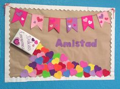 a bulletin board with hearts on it and a tube of toothpaste next to it