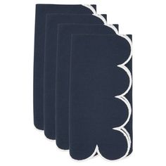 four navy blue napkins with white scalloped edges