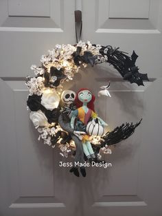 a wreath decorated with halloween decorations on the front door