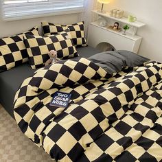 a black and white checkered comforter on a bed