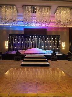 an empty dance floor with lights and chandeliers