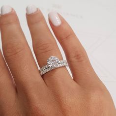 a woman's hand with a diamond ring on it