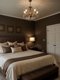 a large bed sitting under a chandelier in a bedroom