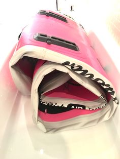 a pink and white bag sitting on top of a table