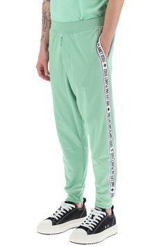 Dsquared2 track pants crafted in cotton and recycled polyester blend jersey. They feature elasticated waistband, side seam pockets, hem with elasticated cuffs and they're characterized by contrasting side bands with logo. Decorated with logo label on the fly. Relaxed fit. The model is 187 cm tall and wears size L. Size Info STANDARD Color Detail Green Made In Italy Material 55% PL 45% CO Season One spring Season Two summer Product clothing Brand Dsquared2 Size And Fit Trench Dress, Latest Fashion Design, Track Pant, Logo Label, The Fly, Jeans Jumpsuit, Knitwear Cardigan, Pant Shirt, Jeans Dress