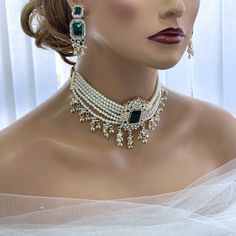 Elevate your special day with our exquisite Bridal Jewelry Set. This Victorian-inspired set features a stunning pearl choker adorned with elegant green stones, perfectly paired with dazzling drop earrings. Ideal for Indian weddings or any special event, this handcrafted set exudes timeless charm and sophistication. Make a statement with genuine, artisanal quality that reflects your unique style. Shop now to add an authentic touch of elegance to your bridal look. Glam Duchess offers a glamour vin Indian Wedding Jewelry Sets, Green Stone Necklace, Special Occasion Jewelry, Bridal Jewelry Set, Green Stones, Perfect Wedding Gift, Indian Wedding Jewelry, Indian Weddings, Swarovski Crystal Earrings