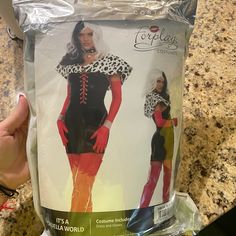 a person holding up a package of costumes