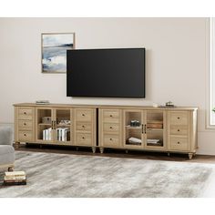 a living room with a large flat screen tv mounted on the wall and wooden furniture