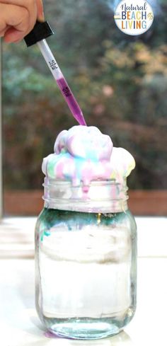 a jar filled with marshmallows and a toothbrush sticking out of it