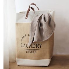 a large laundry bag sitting on top of a wooden floor