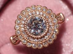 This vintage-inspired Gerbera ring combines the charm of fiery Old European Cut diamond and rose gold milgrained bezel double-halo for a unique engagement ring. The center stone is a charming vintage Old European Cut (OEC) diamond, EGL-USA certified and in pristine condition. The OEC diamonds have gained popularity lately due to their old world character, a beautiful flower-like faceting pattern and amazing fire that is unique to these antique cuts. True vintage OEC diamonds are fairly rare, esp Luxury 14k Rose Gold Halo Setting Rings, Luxury 14k Rose Gold Rings With Halo Setting, Luxury 14k Rose Gold Jewelry With Rose Cut Diamonds, Luxury 14k Rose Gold Jewelry With Halo Setting, Dazzling Rose Gold Rings With Rose Cut Diamonds, Luxury Rose Gold Rings With Halo Setting, Luxury Rose Gold Jewelry With Center Stone, Classic Rose Gold Jewelry With Center Stone, Heirloom Rose Gold Ring With Bezel Setting