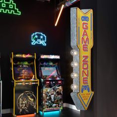 several arcade machines are lined up against the wall