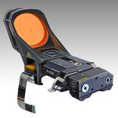 an old style projector is shown with orange light in the center and black strap around it