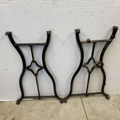 two wrought iron shelf brackets on the side of a wall