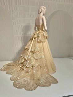 a mannequin dressed in a gold dress on display