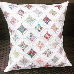 a white pillow with colorful designs on it