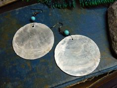 "I love love love the moon, and the sea, and the harbor, so when I found these amazing Capiz shells , I knew exactly how I'd be using them. I paired them with small round Turquoise beads. All the wiring & the French style hook is gunmetal. Each pair is made to order, so anticipate slight differences in your Capiz shell & turquoise stones. Total length is 3\" Enjoy! fyi Capiz shells are somewhat delicate, if you drop them, they will break." Bohemian Shell Earrings For Gift, Handmade Round Shell Jewelry, Bohemian Silver Shell Earrings, Handmade Round Bohemian Shell, Turquoise Bead Earrings, Big Statement Earrings, Earrings Moon, Capiz Shell, Scented Sachets