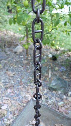 a metal chain is hanging from a tree