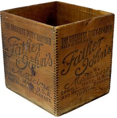 an old wooden crate with some type of label on the front and side, sitting upright against a white background