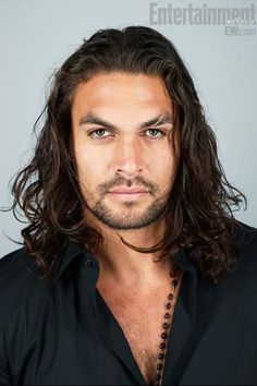 a man with long hair wearing a black shirt