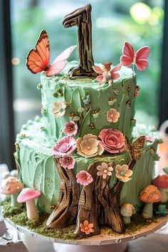 25 1st Birthday Cake Ideas for Your Little One's Big Day Enchanted Garden Cake, Cottage Core Birthday, 1st Birthday Cake Ideas, Woodland Cakes, Enchanted Forest Cake, 1st Birthday Cake Designs, Fondant Numbers, Fairy Garden Cake, Birthday Cake Designs