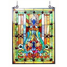 a colorful stained glass window hanging on a wall