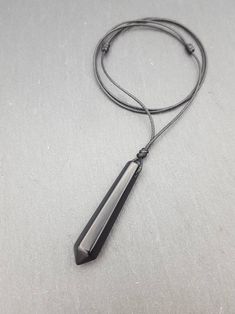 This listing is for 1 (one) necklace.  Materials: - natural Black Obsidian pendant approx. 50mm x 10mm - waxed braided polyester cord Please 💗 my shop to be updated on new creations : AnaDream - https://www.etsy.com/ca/shop/AnaDream IMPORTANT - PLEASE READ ✤ Necklace sizing (Exception: adjustable cord necklaces) ✤ It is very important to select the correct length when you place the order. Please make sure to measure your neck (or an older necklace you own) before purchasing and select the prope Black Pendant Crystal Necklaces For Meditation, Black Crystal Pendant Necklaces For Meditation, Black Pendant Crystal Necklace For Meditation, Adjustable Black Crystal Pendant Necklace, Minimalist Black Pendant Crystal Necklace, Minimalist Adjustable Black Crystal Necklace, Minimalist Black Adjustable Crystal Necklace, Minimalist Black Crystal Necklace As A Gift, Cord Necklaces