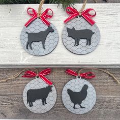 two christmas ornament shaped like cows with red bows on the front and back