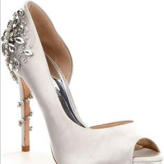 a white high heeled shoe with crystal embellishments