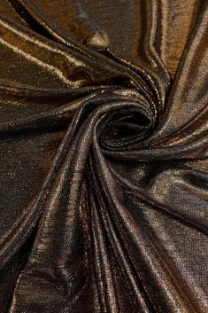 Bronze Metallic Foil Lame fabric is a luxurious fabric that is shiny and colorful. Lame (pronounced la-may) is usually a knit fabric with a metallic coating on the surface. This Bronze Metallic Foil Lame fabric is gorgeous and lightweight, has a beautiful metallic look and a crispy textured feel. Perfect for costume, performance wear, upholstrey, draperies, cushion, slip covers, skirts, jackets and dresses. Purchase fabric by the Yard at NY Designer Fabrics. The fabric measures 58/60 inches in width. Mini Project, Lame Fabric, Midas Touch, Slip Covers, Deep Autumn, Metallic Look, Dupioni Silk, Luxurious Fabric, Metallic Prints