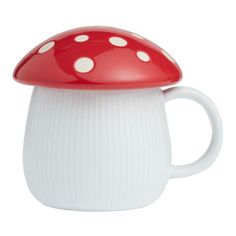 a red and white mushroom shaped coffee mug with polka dots on the top, sitting in front of a white background