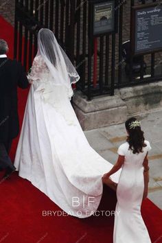 the bride is walking down the red carpet