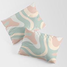 two decorative pillows with pastel colors on them