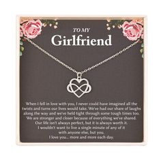 a necklace with the words to my girlfriend written on it and two intertwined hearts