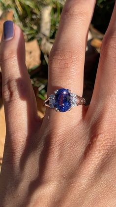 Indulge in unique, eye-catching beauty with this Deep Blue Tanzanite Ring! Set in 14K Solid White Gold with natural diamond accents, it radiates luxury and sophistication. Its 10x8mm oval tanzanite flashes purple and red, creating an aura of elegance. Perfect for anyone born in December, it's sure to make a statement! ~~~~~~ This ring is made with solid 14k gold and natural earth mined SI G/H diamonds. As listed, this ring is ready to ship. If you're interested in purchasing this setting with a Dazzling Oval Sapphire Gemstones, Oval Tanzanite Diamond Ring With Accent Stones, Oval Tanzanite Gemstones In Prong Setting, Oval Tanzanite Diamond Ring In White Gold, Oval Tanzanite Sapphire Ring, Oval Tanzanite Ring With Brilliant Cut, Oval Tanzanite Diamond Ring For Gift, Oval Tanzanite Diamond Ring As A Gift, Oval Tanzanite Rings Fine Jewelry