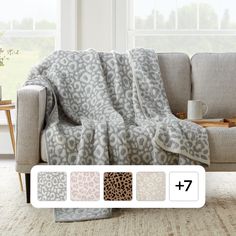 the leopard print blanket is on display in front of a couch