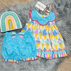 Nwt. Absolutely Adorable. Bright Colors, Bold Print Ruffles And Pom Pom Trim. Top Flares Out, Scalloped Collar, Back Buttons With Mj Logo Patch Near Bottom Hemline, Matching Bloomer Shorts, Fixed Bow With Elasticized Waistband. Size 6/12 Months Bin: K22 Playful Ruffled Sets For Playtime, Playful Spring Sleepover Sets, Playful Spring Sets For Playdate, Playful Sets For Playdate In Spring, Multicolor Playwear Sets For Spring, Playful Playwear Sets For Spring, Playful Spring Playwear Sets, Blue Cotton Set For Birthday, Cute Summer Sets For Playdate