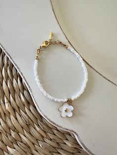 White and gold flower baby bracelet | Baby shower present | Baby bracelet | Baby girl bracelet | Flower bracelet charm West Wood Sign Co D E T A I L S: Gold Plated clasp and chain P L E A S E  R E A D: When measuring wrist add 1/2 inch! All items are handmade and slight variations may occur with each piece.  Follow us on Instagram @WestWoodSignCo https://www.etsy.com/shop/WestWoodSignCo Dainty White Charm Bracelet For Everyday, White Charms Bracelets For Birthday Gift, White Charm Bracelet For Birthday, Cute White Jewelry With Lobster Clasp, White Dainty Beaded Bracelet With Flower Charm, Dainty White Beaded Bracelet With Flower Charm, Flower Charm Bracelet As A Gift, Adjustable White Charm Bracelet With Flower Charm, White Adjustable Charm Bracelet With Flower Charm