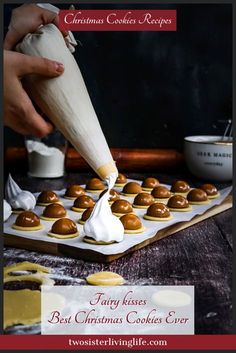 a person is spreading icing on some cookies in the shape of christmas puddings